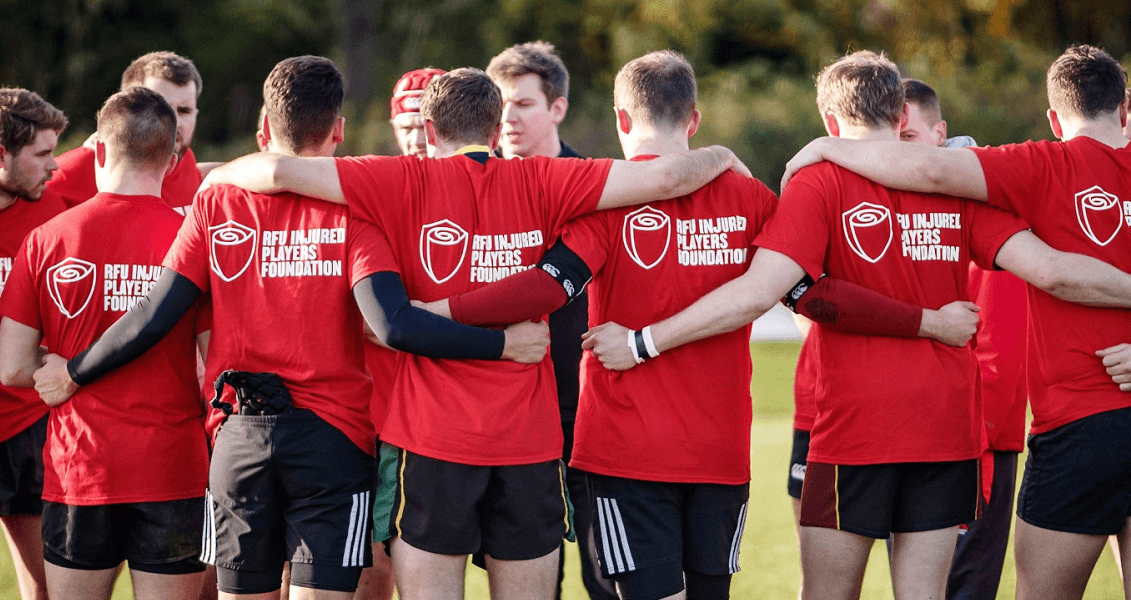 Rugby players huddle in IPF shirts