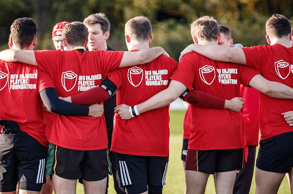 Rugby players huddle in IPF shirts