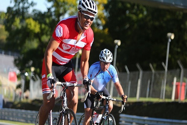 2 cyclists, one wearing an RFU Injured Players Foundation shirt